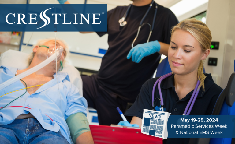 Two paramedics provide care to a patient inside an ambulance, with one taking notes and the other monitoring the patient’s condition. The Crestline logo appears in the upper left, and a banner in the lower right highlights Paramedic Services Week and National EMS Week, May 19–25, 2024