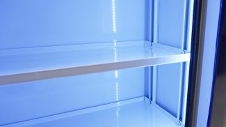 Close-up of illuminated interior storage shelves inside a Crestline ambulance cabinet, featuring smooth white surfaces and integrated LED lighting