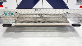 Close-up of a Crestline ambulance rear step bumper with diamond plate aluminum and Saskatchewan license plate